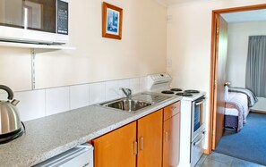 Family Apartment | Private kitchen | Fridge, microwave, electric kettle, cookware/dishes/utensils