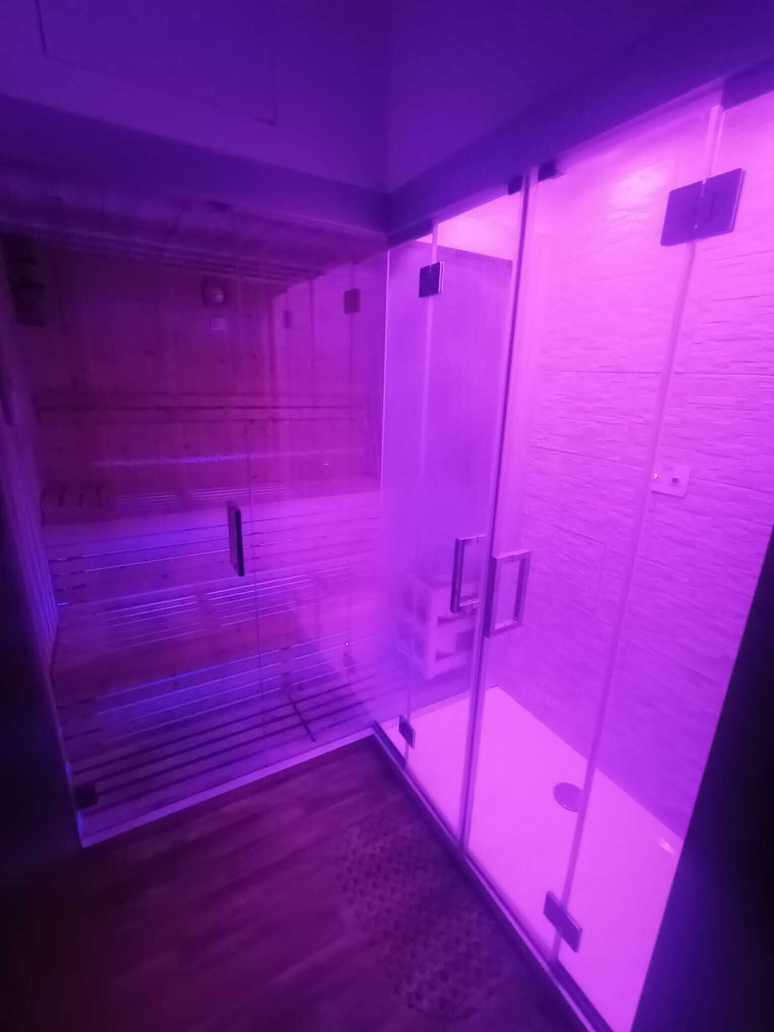 A room with a sliding glass door, a wooden floor, and a visible ceiling vent.