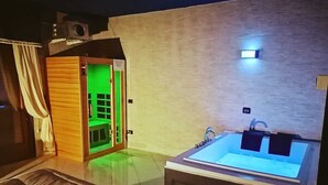 A modern bathroom with a large bathtub, a shower area, and a wooden cabinet. - Royal Hotel Montevergine (Ospedaletto D'Alpinolo)