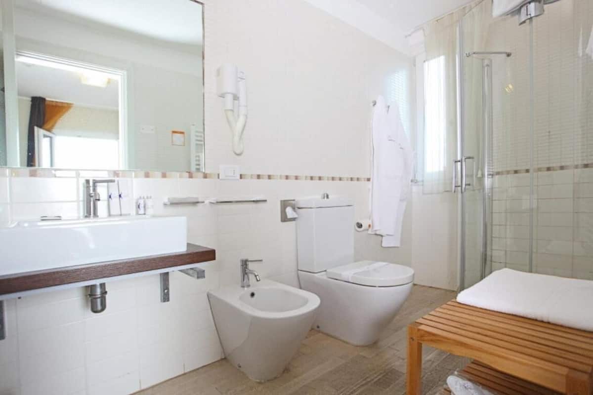 designer toiletries, hair dryer, bidet, towels