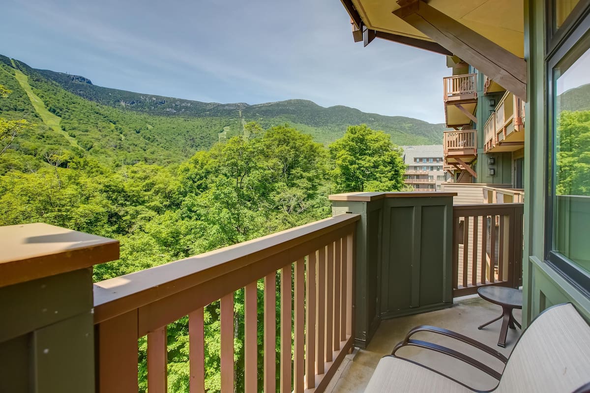 A balcony with a view of a mountainous landscape.