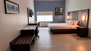 A modern bedroom with a bed, desk, and bench. - La Quinta Inn & Suites by Wyndham Alamo - McAllen East (Alamo)