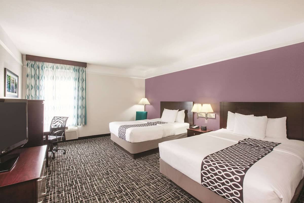 Premium bedding, desk, laptop workspace, blackout drapes
