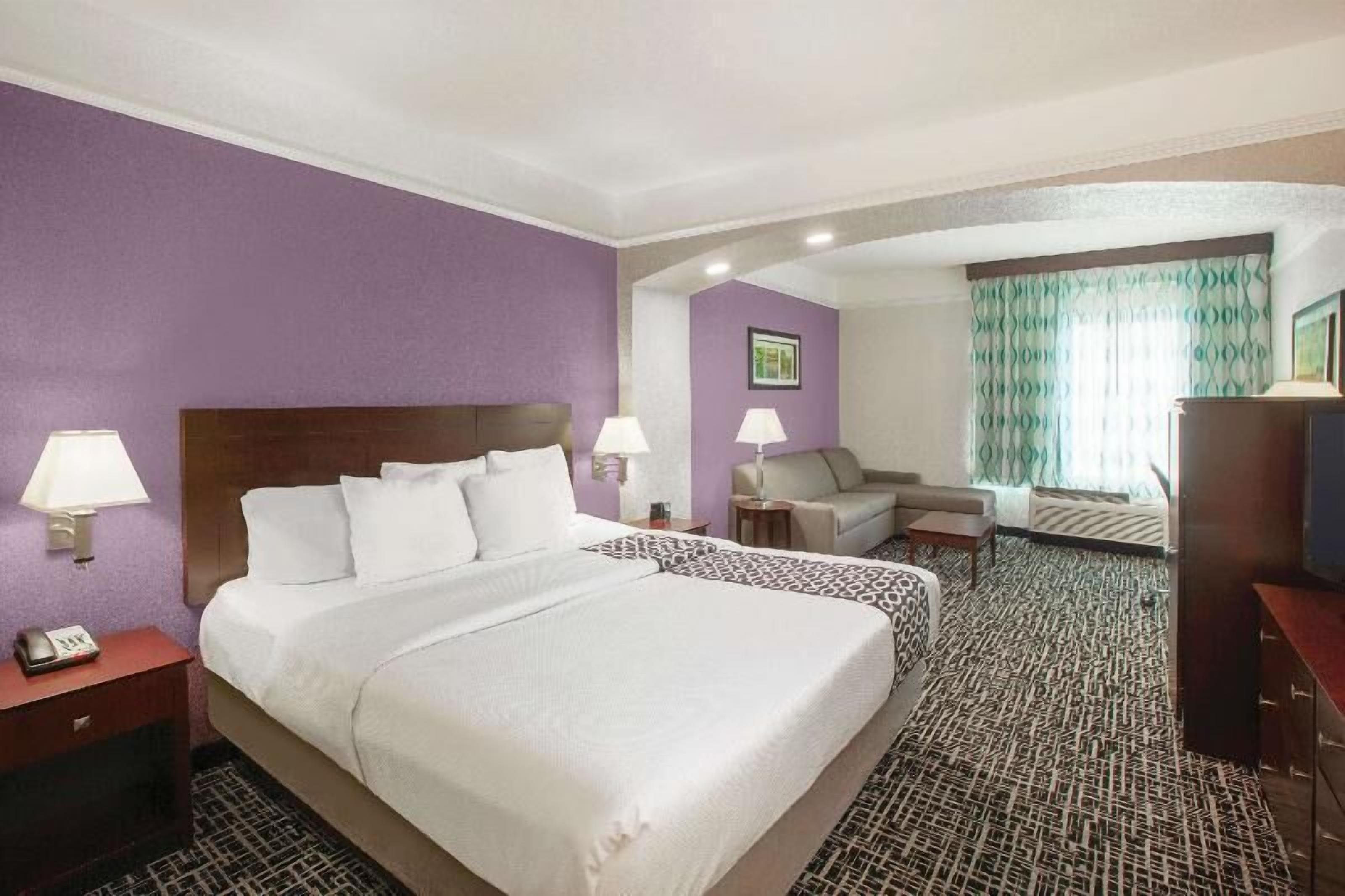 Premium bedding, desk, laptop workspace, blackout curtains