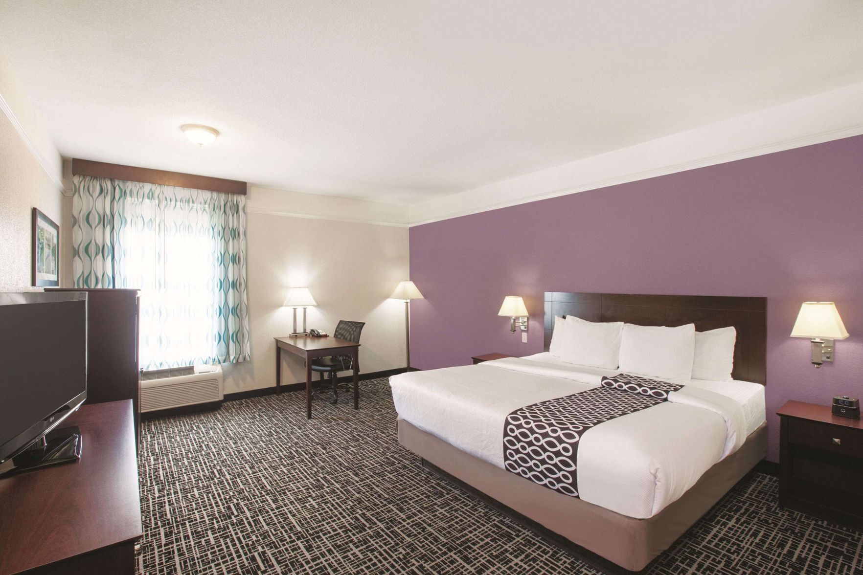 Premium bedding, desk, laptop workspace, blackout curtains