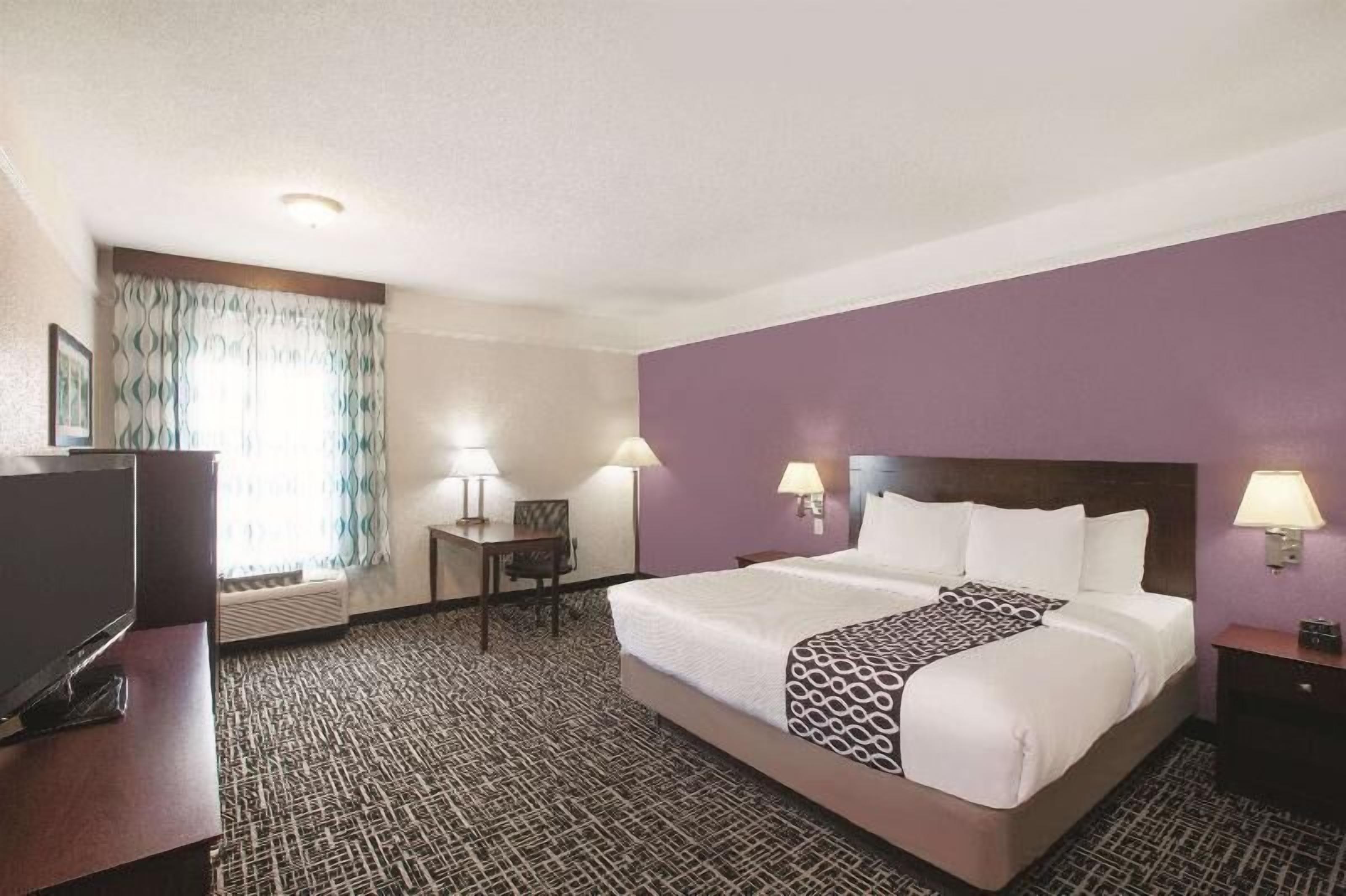 Premium bedding, desk, laptop workspace, blackout curtains