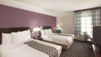 Premium bedding, desk, laptop workspace, blackout drapes