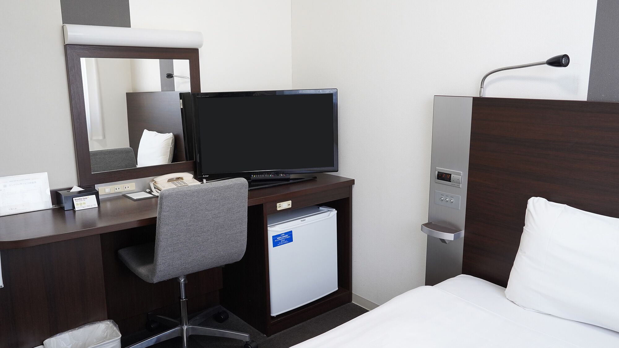 Premium bedding, desk, laptop workspace, blackout drapes
