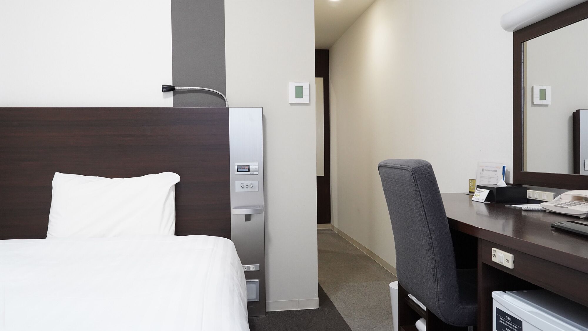 Premium bedding, desk, laptop workspace, blackout drapes