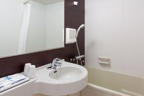 Een badkamer met een witte wastafel, spiegel en douche.