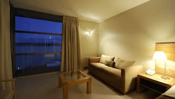 Junior Suite, 1 King Bed | Living room | 32-inch flat-screen TV with cable channels, TV, pay films