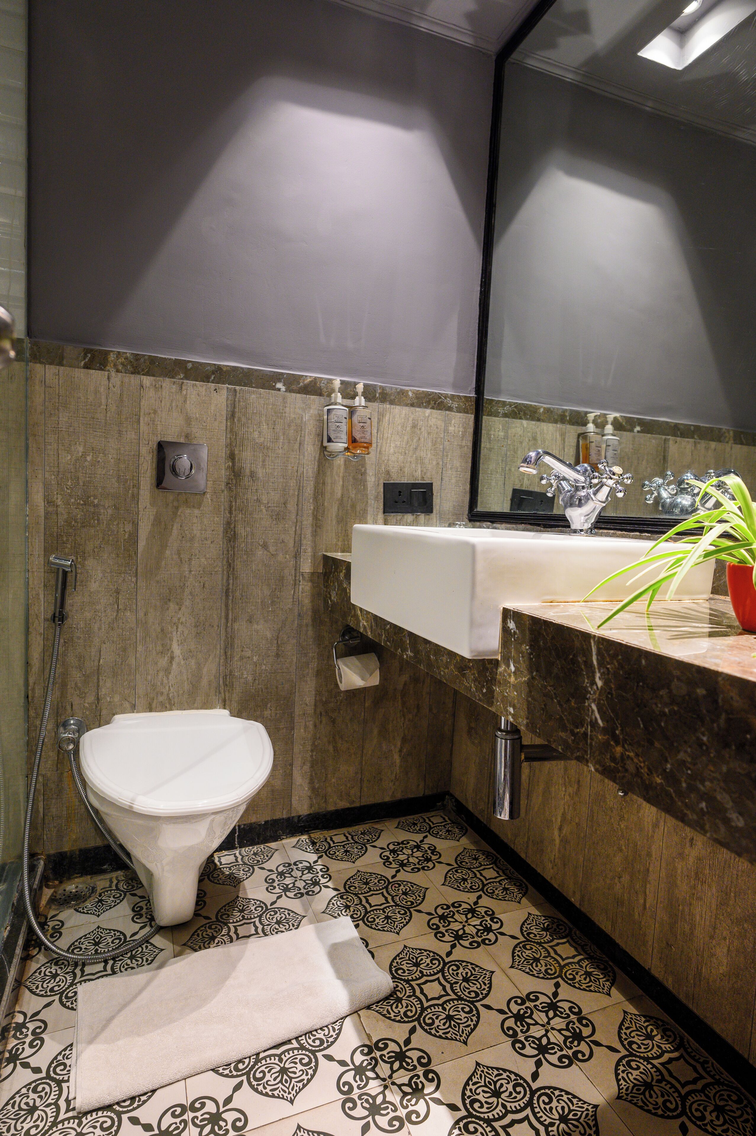 A bathroom with a toilet, sink, and shower.