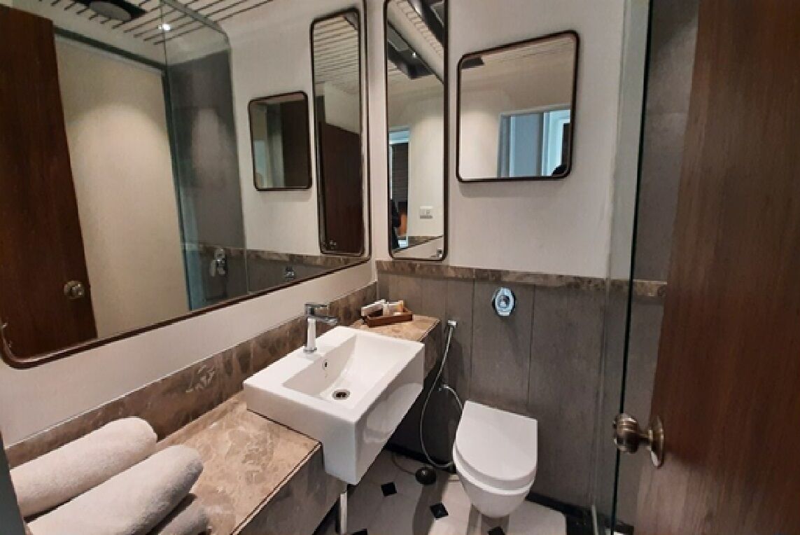 A bathroom with a sink, mirror, and toilet.