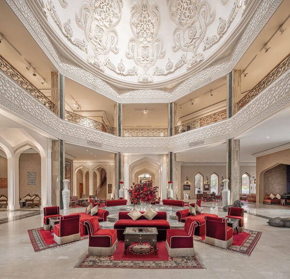 A grand lobby with a central seating area, high ceilings with intricate designs, and a symmetrical layout. - Es Saadi Marrakech Resort Palace (Marrakech)