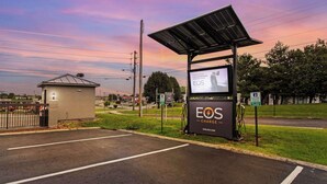 A solar-powered charging station with a sign advertising EOS Charge. - Quality Inn White House (White House)
