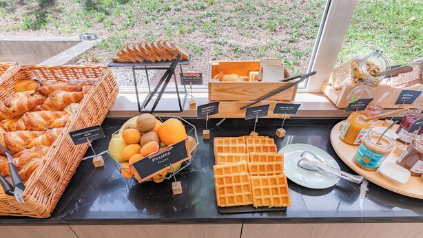 A breakfast buffet with croissants, fruits, waffles, and various spreads. - Appart'City Confort Montpellier Gare Saint Roch (Montpellier)