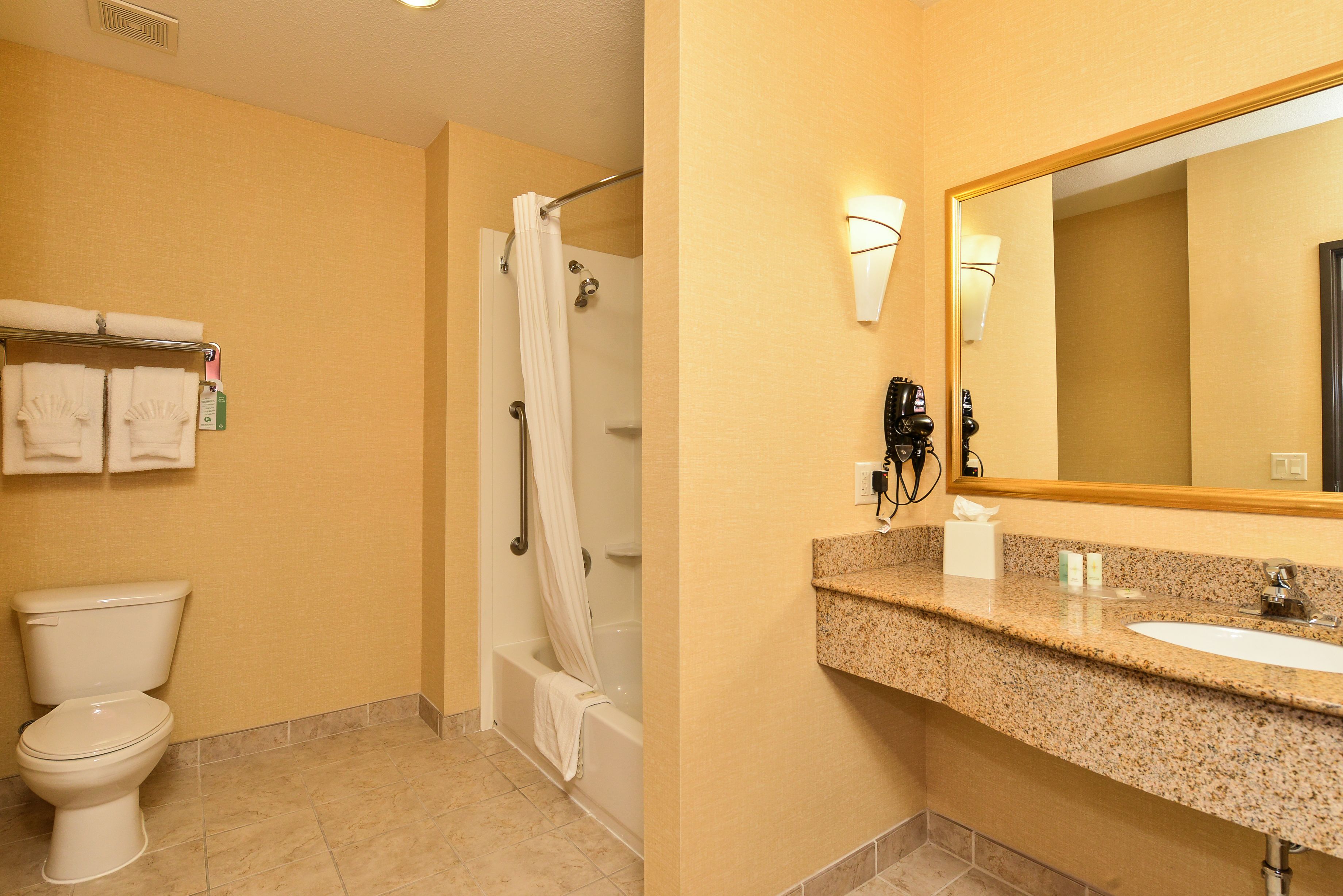 suite, 1 king bed, 2 person sofa bed, non smoking | bathroom | combined shower/bathtub, hair dryer, towels