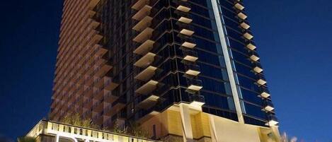 A tall hotel building with the name 'PALMS PLACE' prominently displayed at the top.