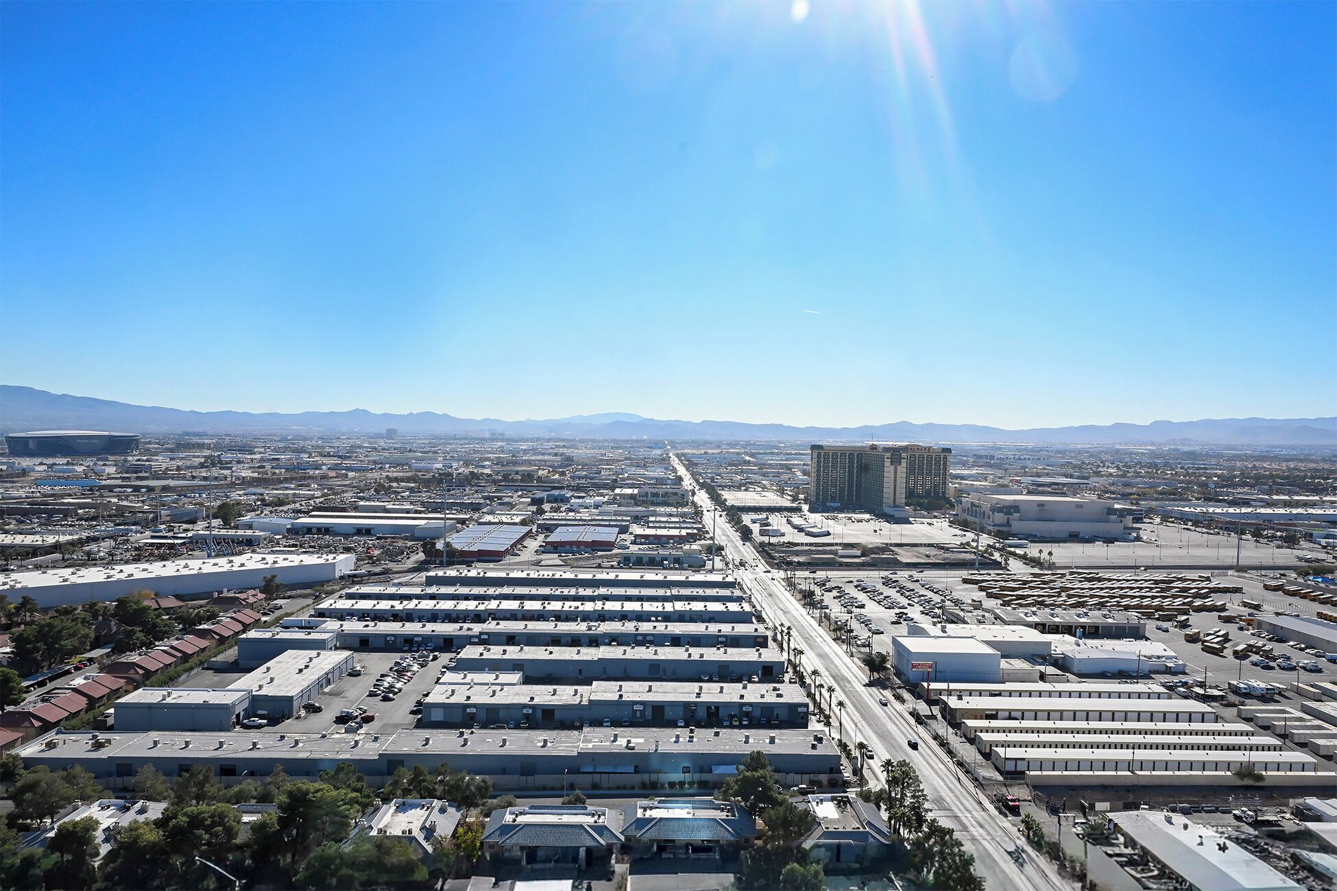 A large industrial area with multiple warehouses and a prominent hotel building.