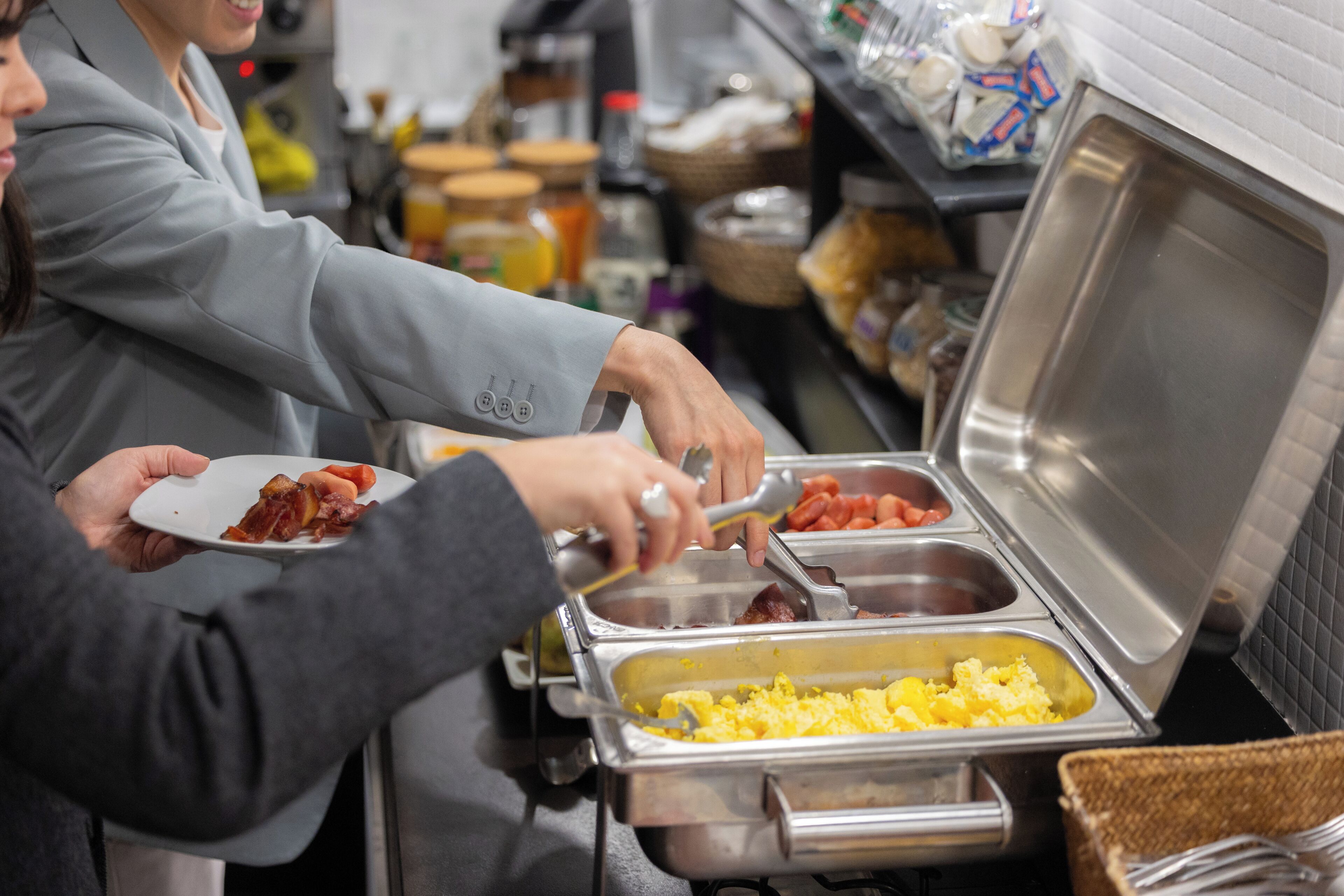 A buffet setup with various food items in metal containers.
