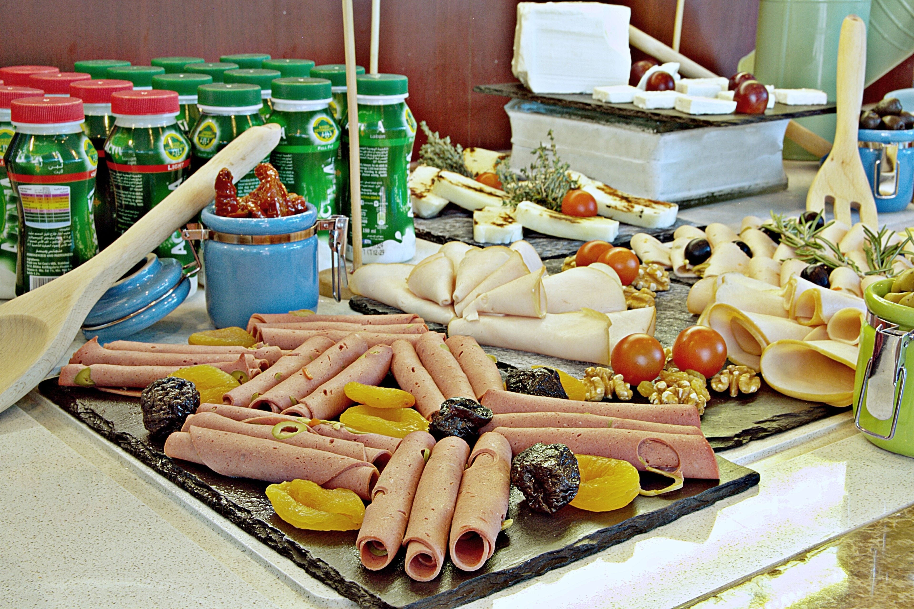 A variety of food items including meats, cheeses, and fruits arranged on a table.