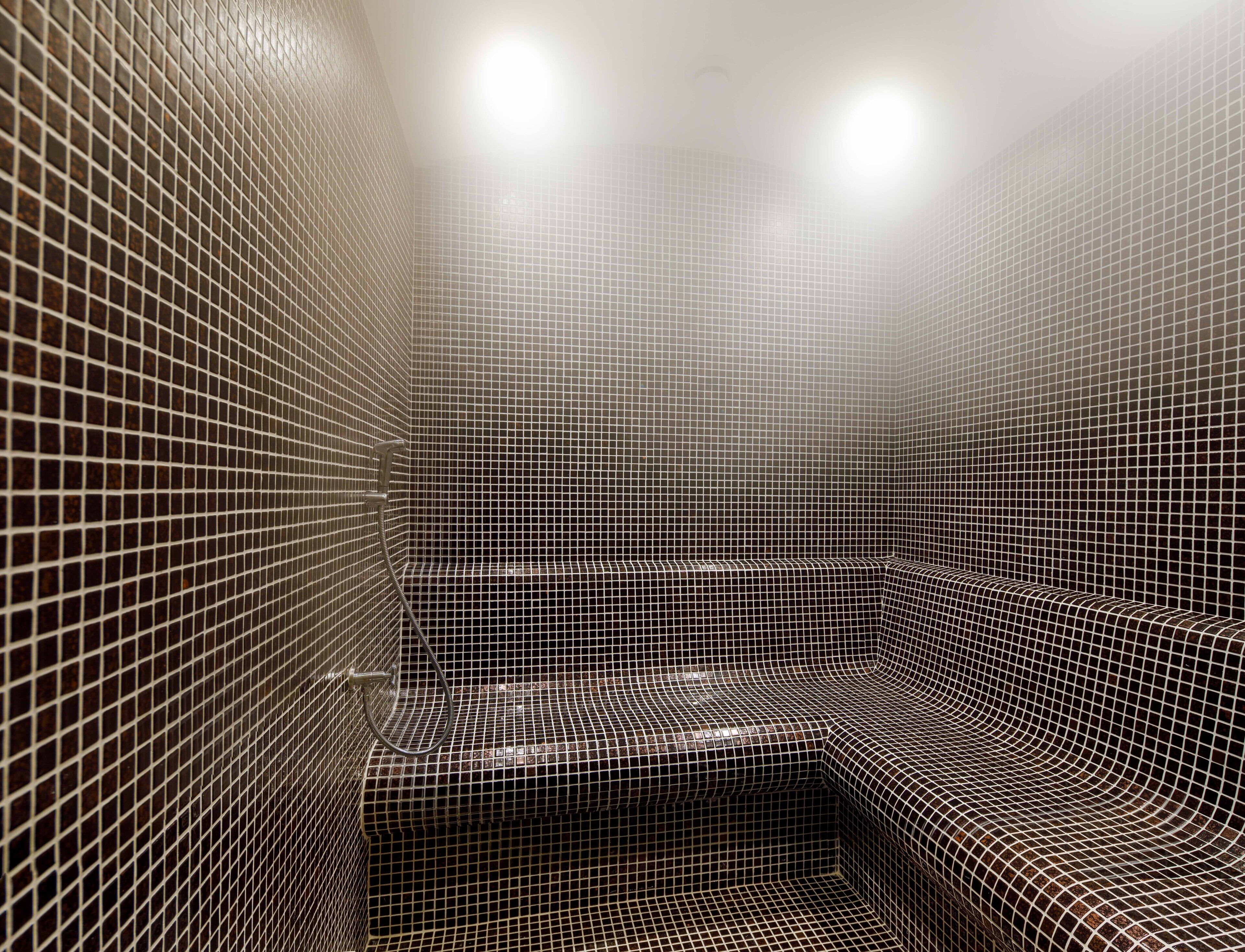 A tiled bathroom with a shower area.