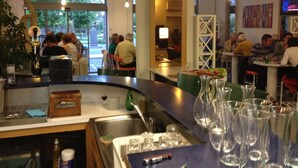 A restaurant interior with a bar area, seating for guests, and a view of the outdoors.