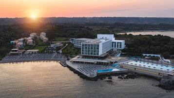 Enjoy a refreshing swim in the hotel's outdoor pool area surrounded by a rocky shoreline.