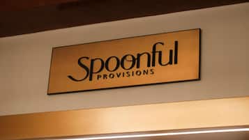 A sign with the text 'Spoonful Provisions' on a wall.