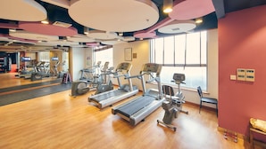 A gym with treadmills, elliptical machines, and other fitness equipment. - Parkview Hotel Shanghai (Shanghai)