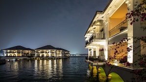 A waterfront hotel with multiple balconies and a reflective pool. - InterContinental Hanoi Westlake by IHG (Hanoi)