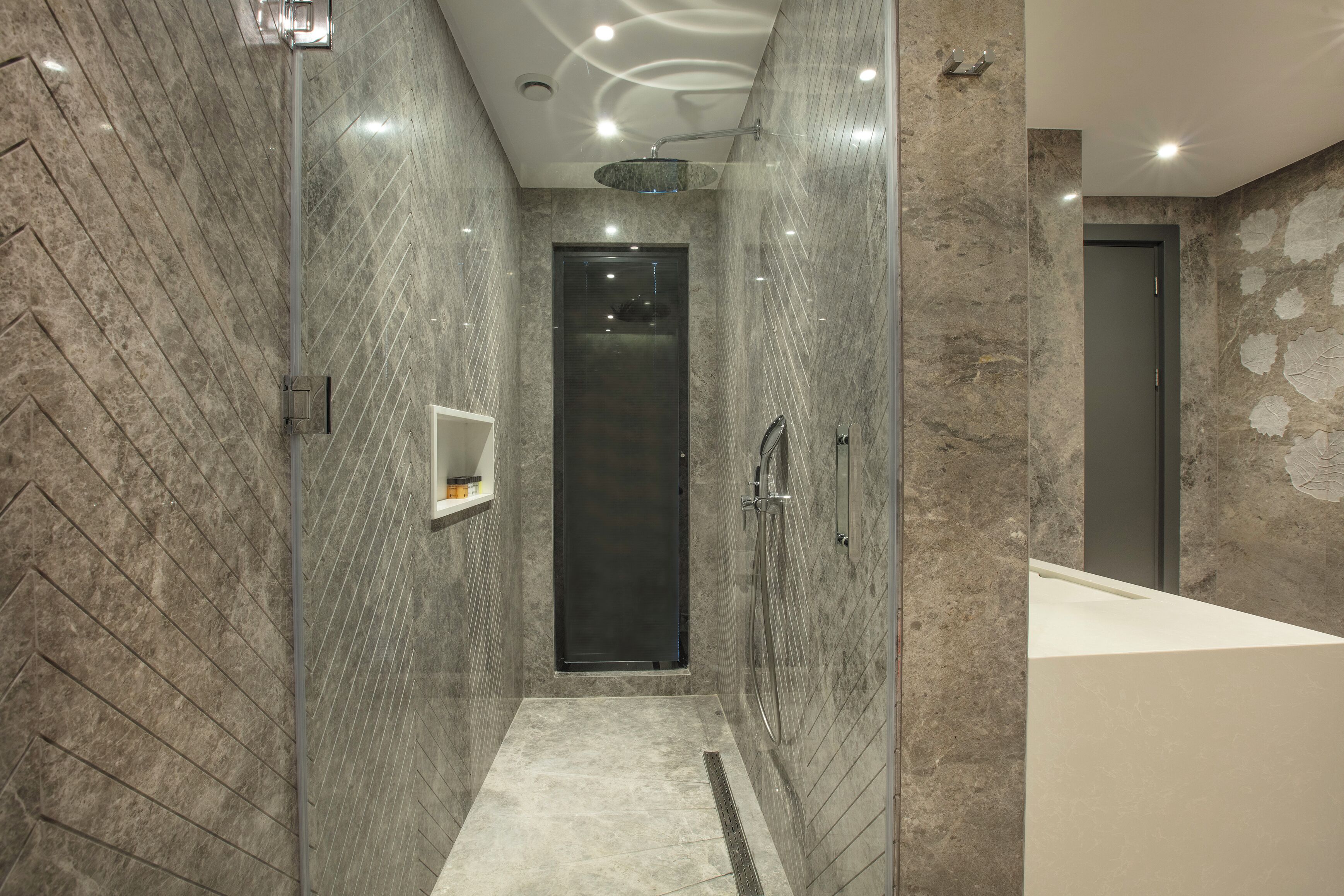 A modern bathroom with a walk-in shower, a bathtub, and a vanity.