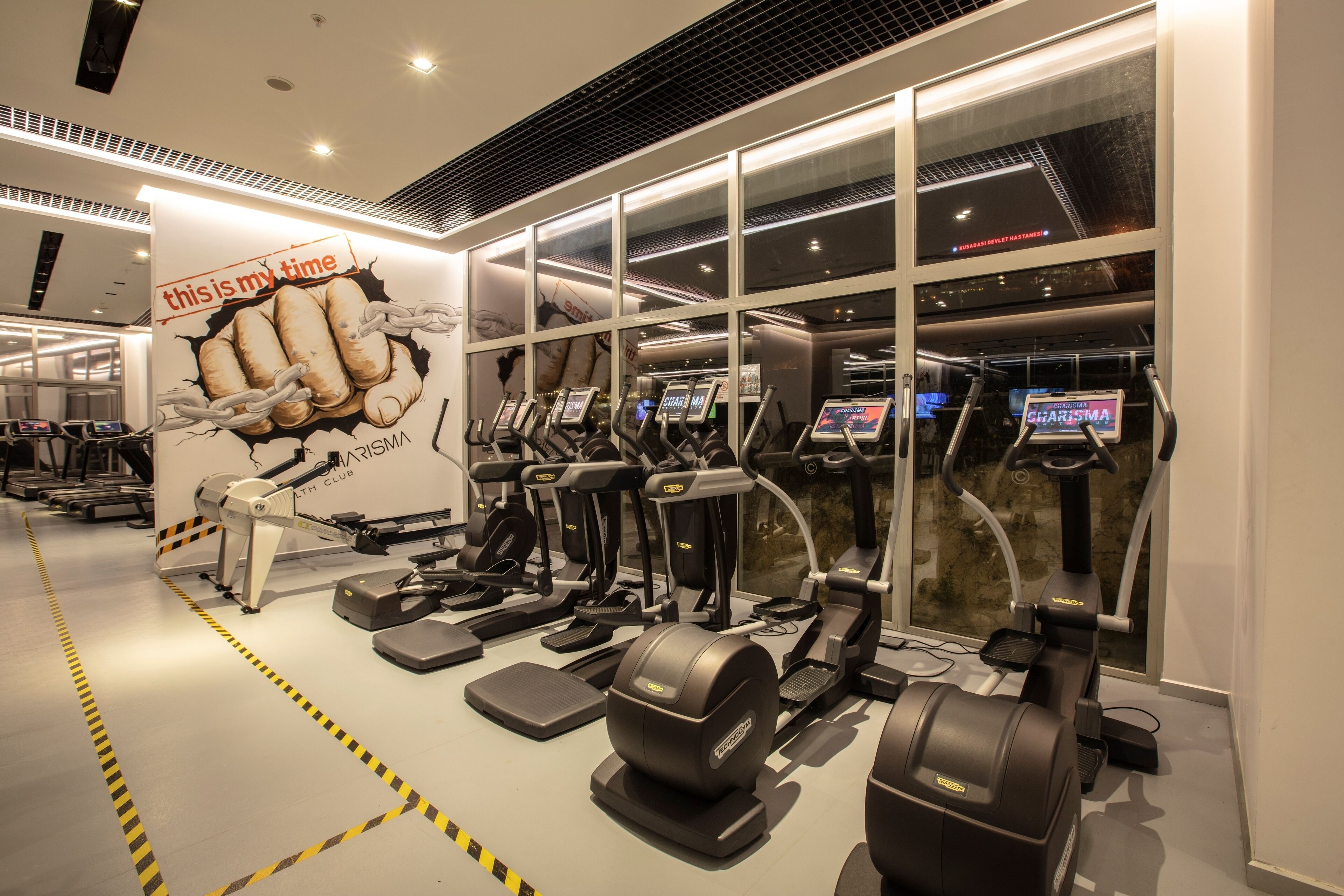 A gym with treadmills, elliptical machines, and weight machines.