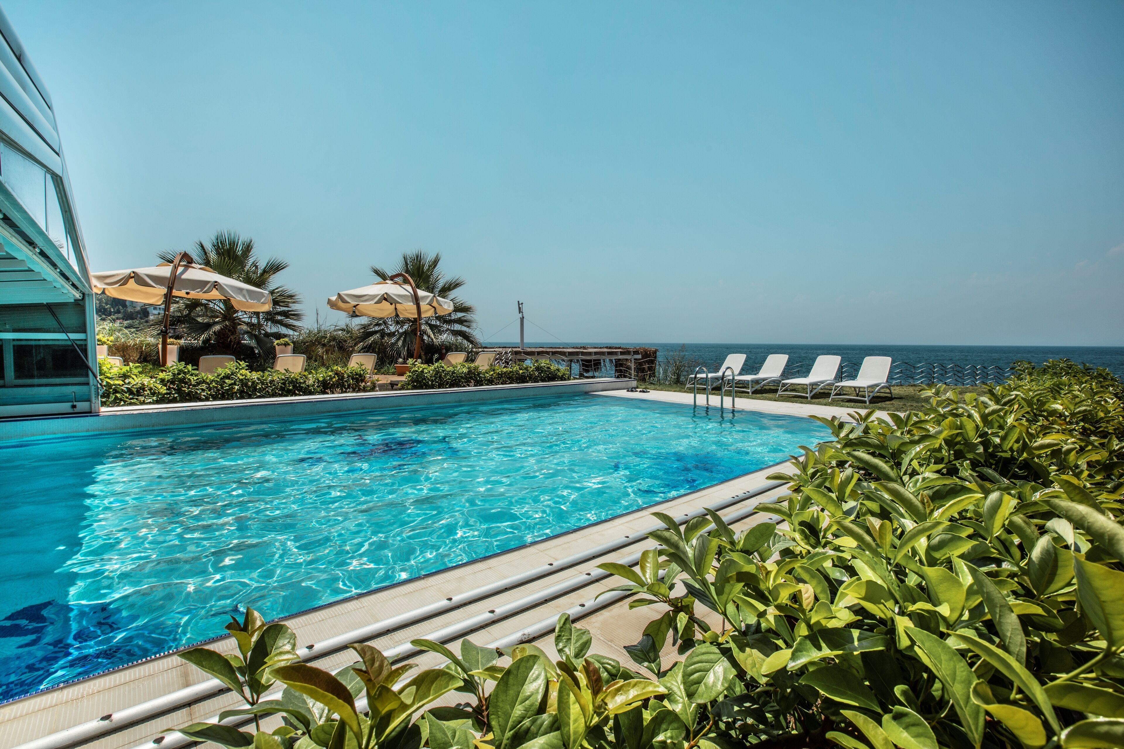 indoor pool, outdoor pool, pool umbrellas, pool loungers