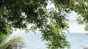 A breakfast buffet with a variety of dishes, a view of the sea, and outdoor seating. - Charisma De Luxe Hotel (Kusadasi)