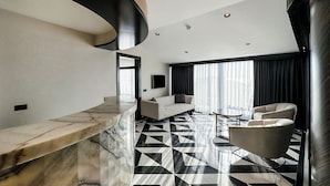 A modern living room with a marble bar, a sofa, and a coffee table. - Charisma De Luxe Hotel (Kusadasi)