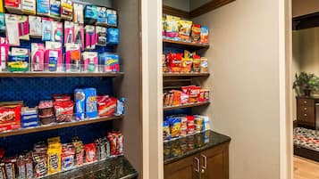 A well-stocked pantry with various food items and household goods.