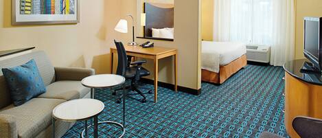 Premium bedding, desk, laptop workspace, blackout drapes