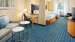 A hotel room with a bed, desk, chair, and a television. - Fairfield Inn & Suites by Marriott San Antonio Seaworld (San Antonio)