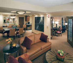 A hotel room with a living area, dining area, and kitchenette. - Embassy Suites by Hilton Norman Hotel & Conference Center (Norman)