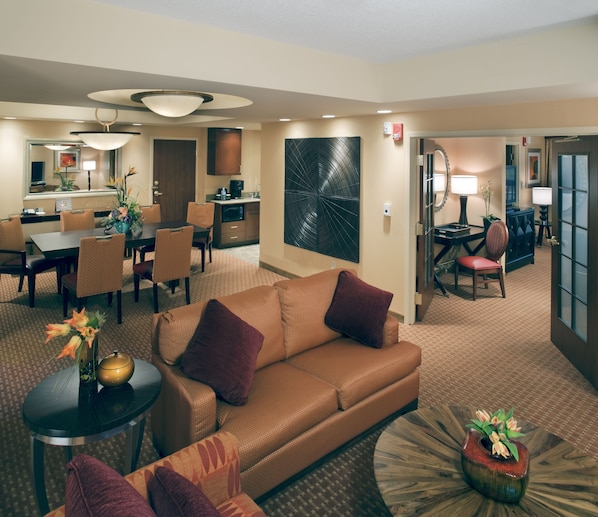 A hotel room with a living area, dining area, and kitchenette. - Embassy Suites by Hilton Norman Hotel & Conference Center (Norman)