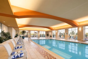An indoor swimming pool with lounge chairs and a tiled floor. - Embassy Suites by Hilton Norman Hotel & Conference Center (Norman)