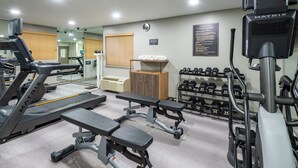 A gym with treadmills, benches, dumbbells, and a mirrored wall. - Candlewood Suites Chesapeake/Suffolk by IHG (Chesapeake)