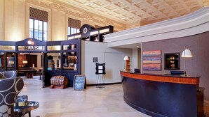 A spacious lobby with a reception desk, a bar area, and a seating area with patterned chairs. - Residence Inn by Marriott Columbus Downtown (Columbus)