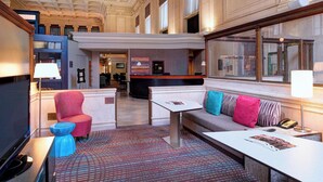 A lobby with a reception desk, seating area, and a patterned carpet. - Residence Inn by Marriott Columbus Downtown (Columbus)