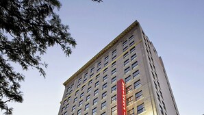A tall building with a prominent red sign, large windows, and classical architecture. - Residence Inn by Marriott Columbus Downtown (Columbus)