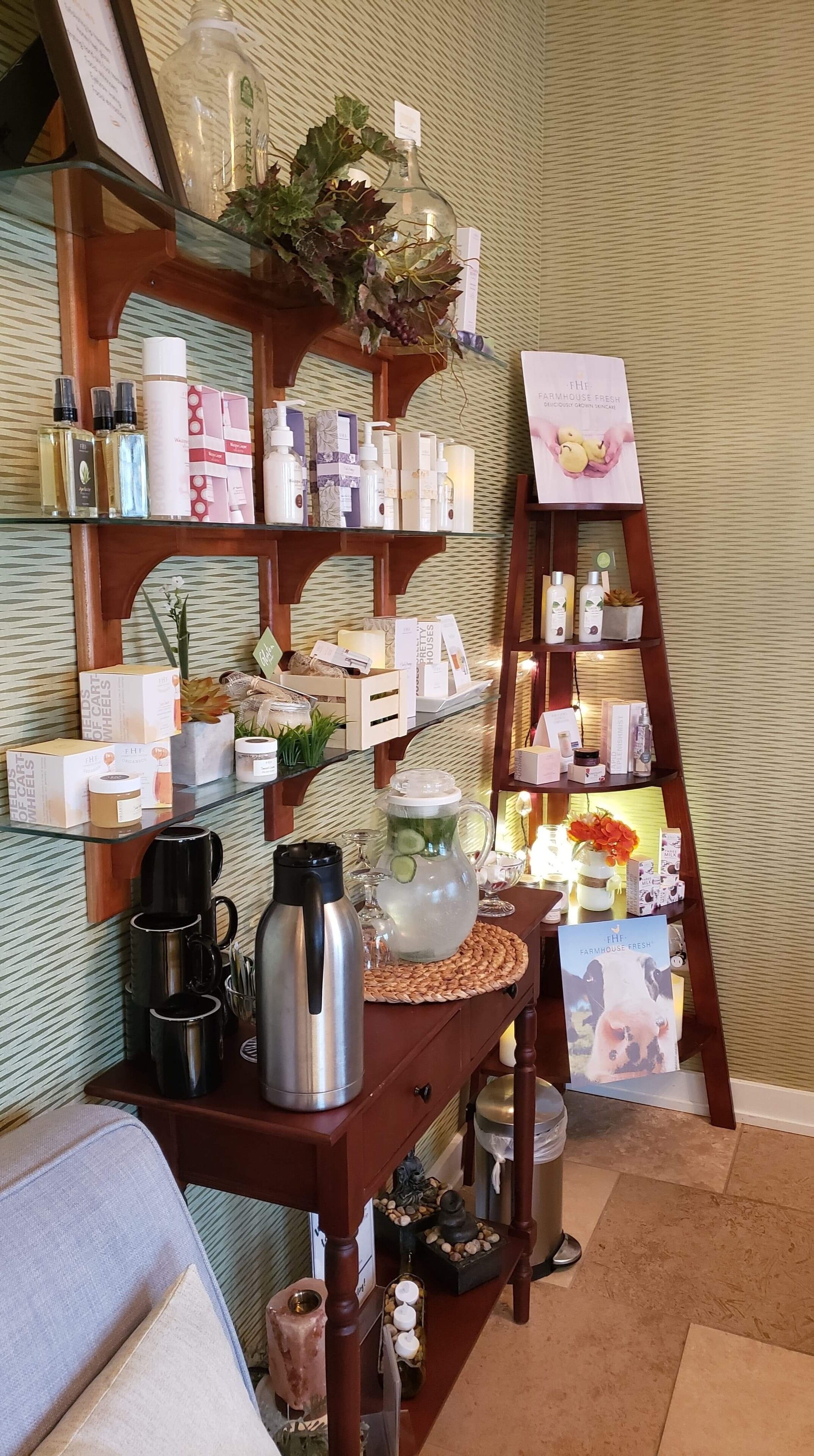 A neatly organized room with shelves displaying various products, a coffee maker, and a decorative pitcher.