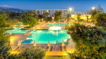 Relax by the pool surrounded by lush greenery and take in the breathtaking views of the surrounding mountains.