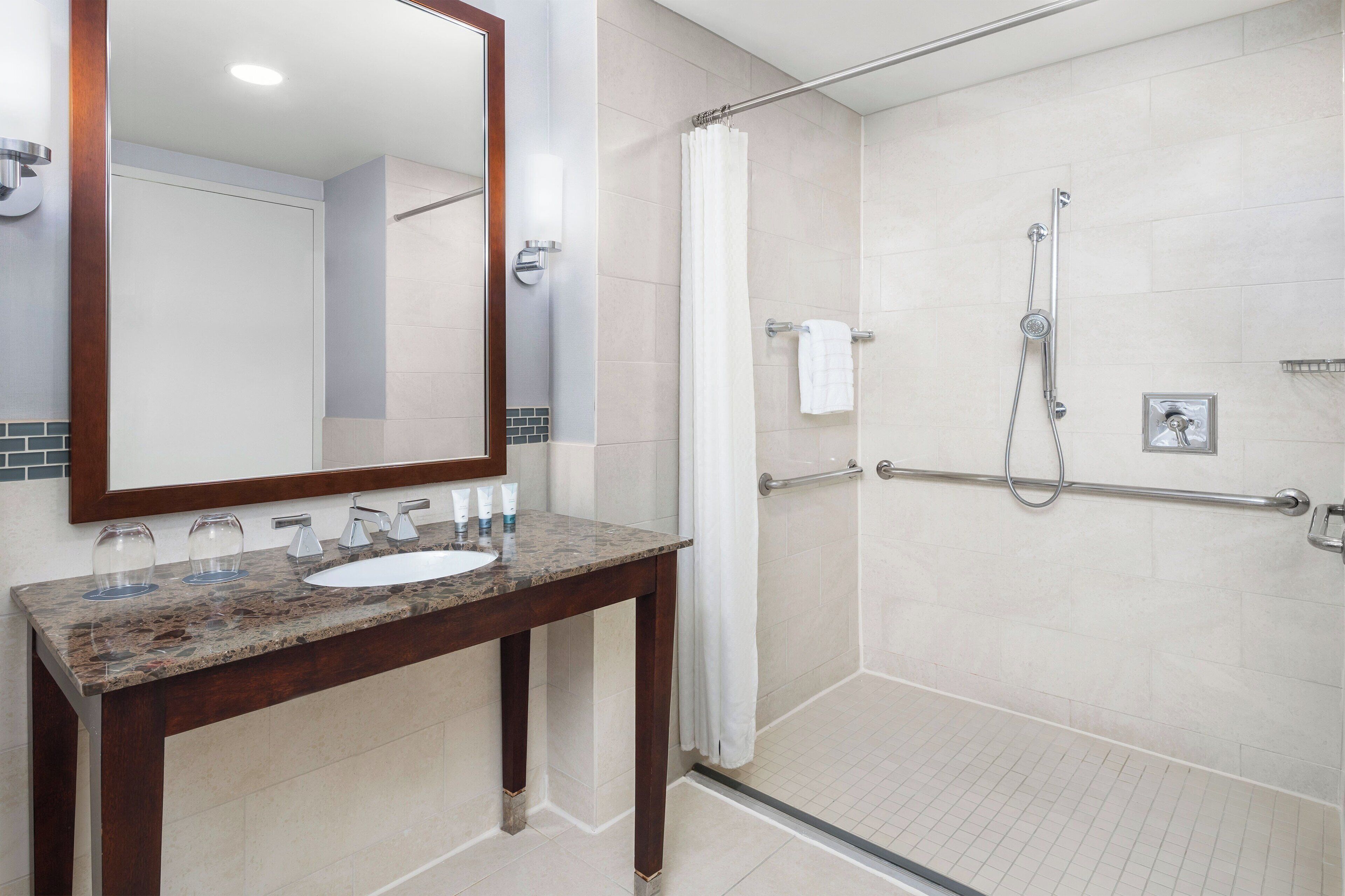 combined shower/bathtub, designer toiletries, hair dryer, bathrobes