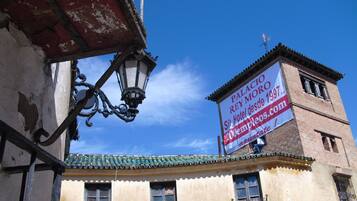 A historic building with a sign advertising a hotel.